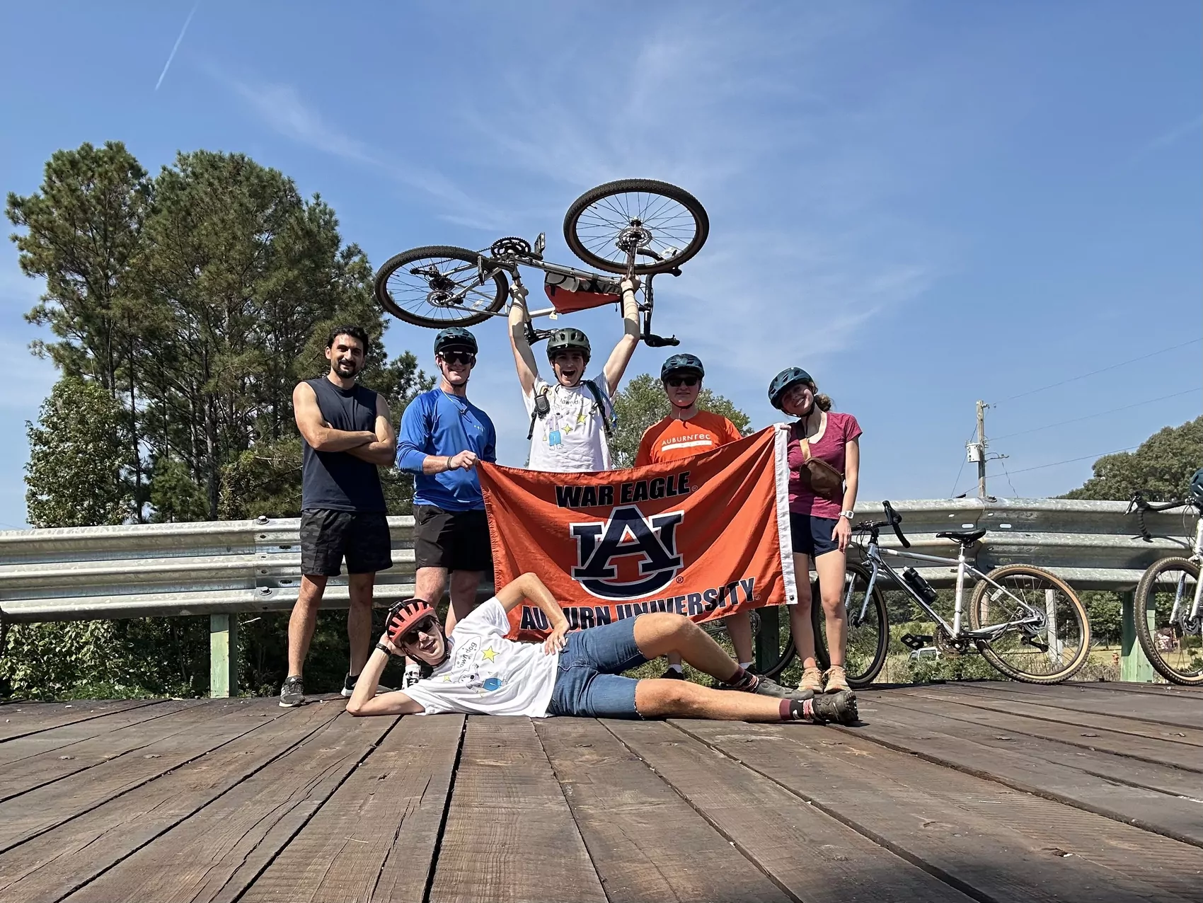A group of students hold an Auburn University flag.